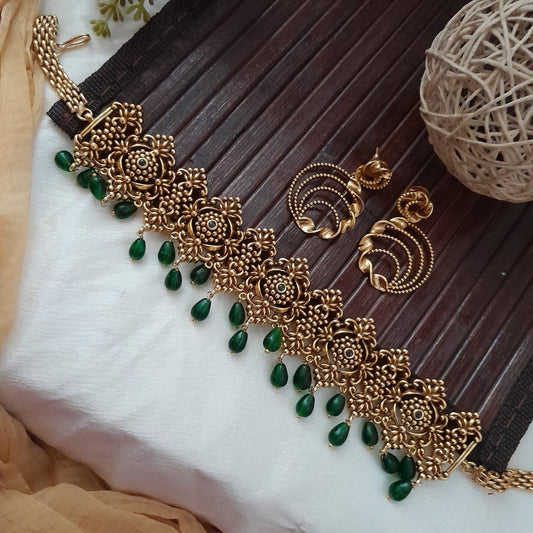 Floral-patterned choker adorned with elegant green drops