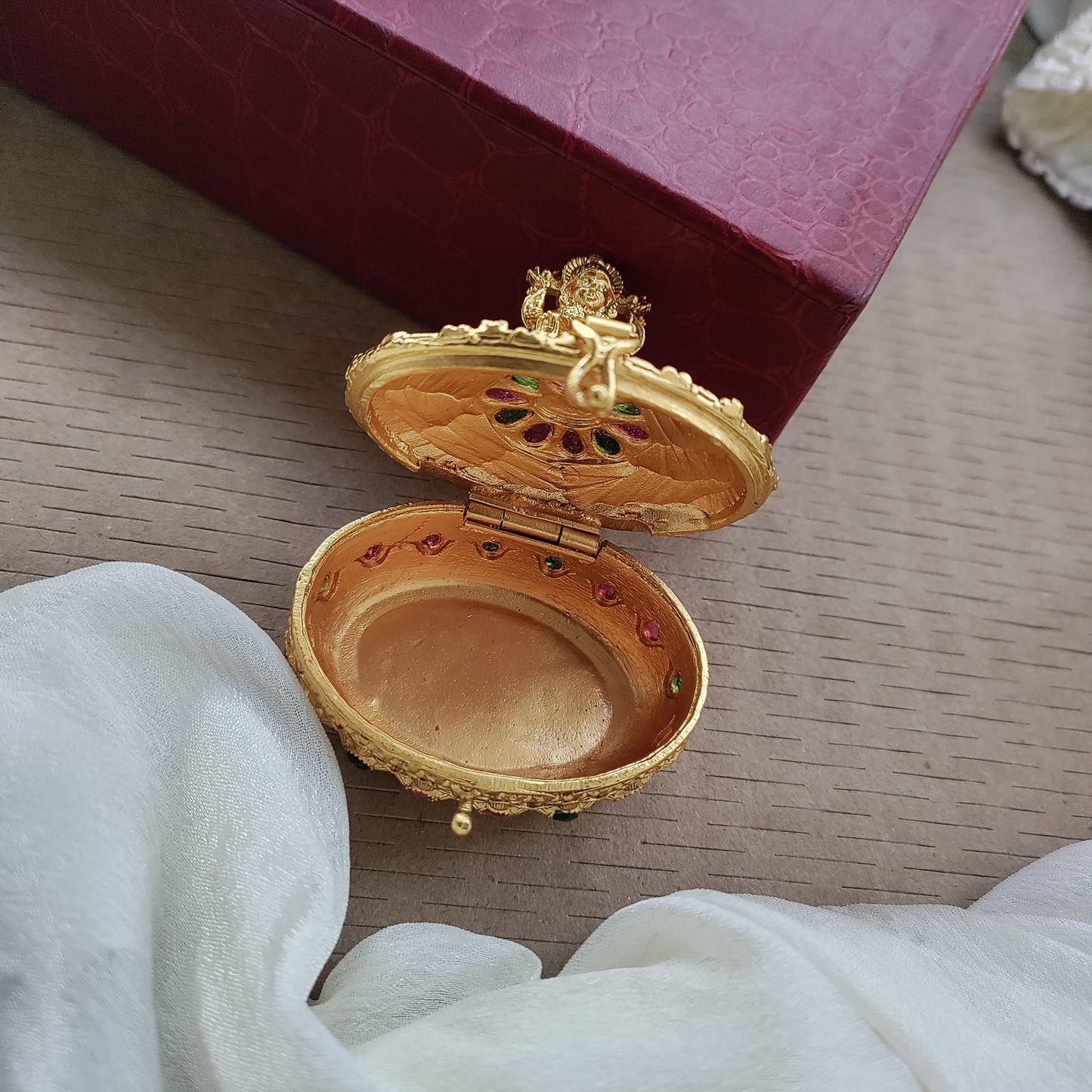 Oval shaped sindoor box with lakshmi