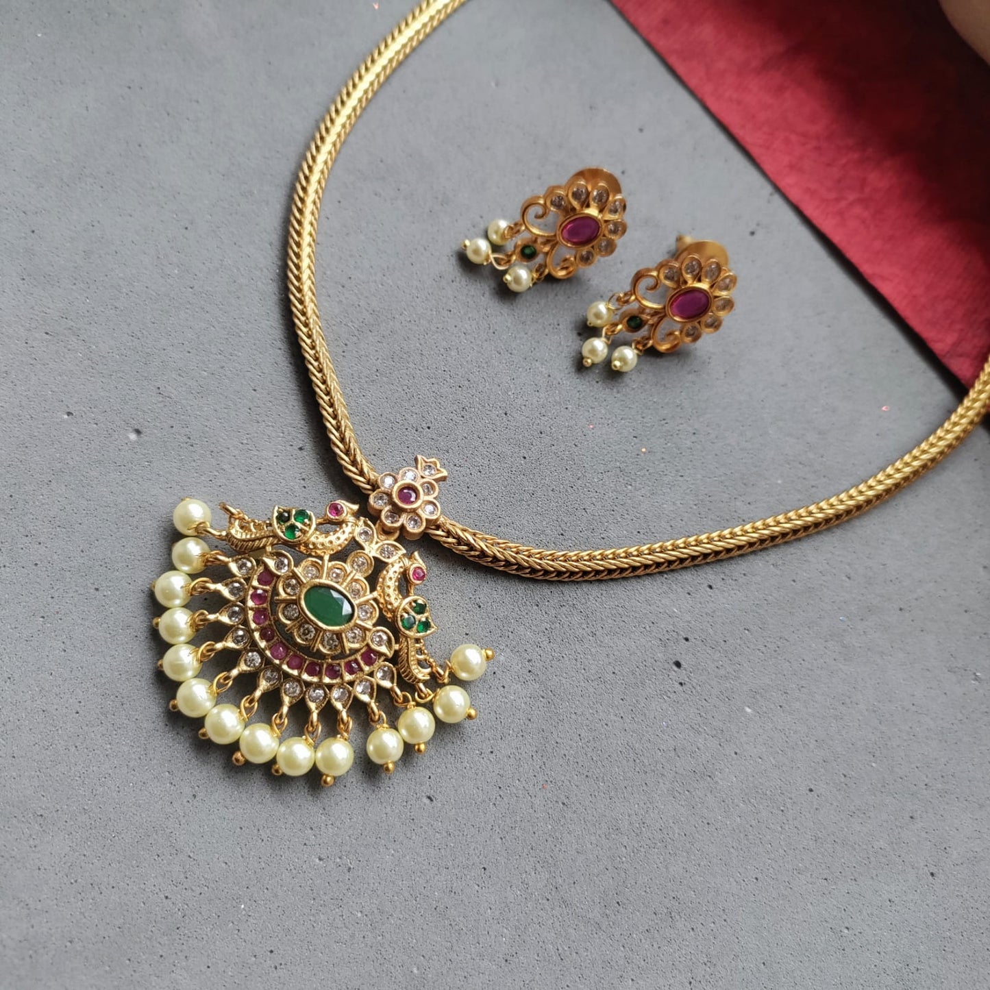 Simple slim adigai with white stone studded pendant and pearl drop