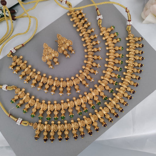 Golden necklace with ruby/emerald/pearl stone