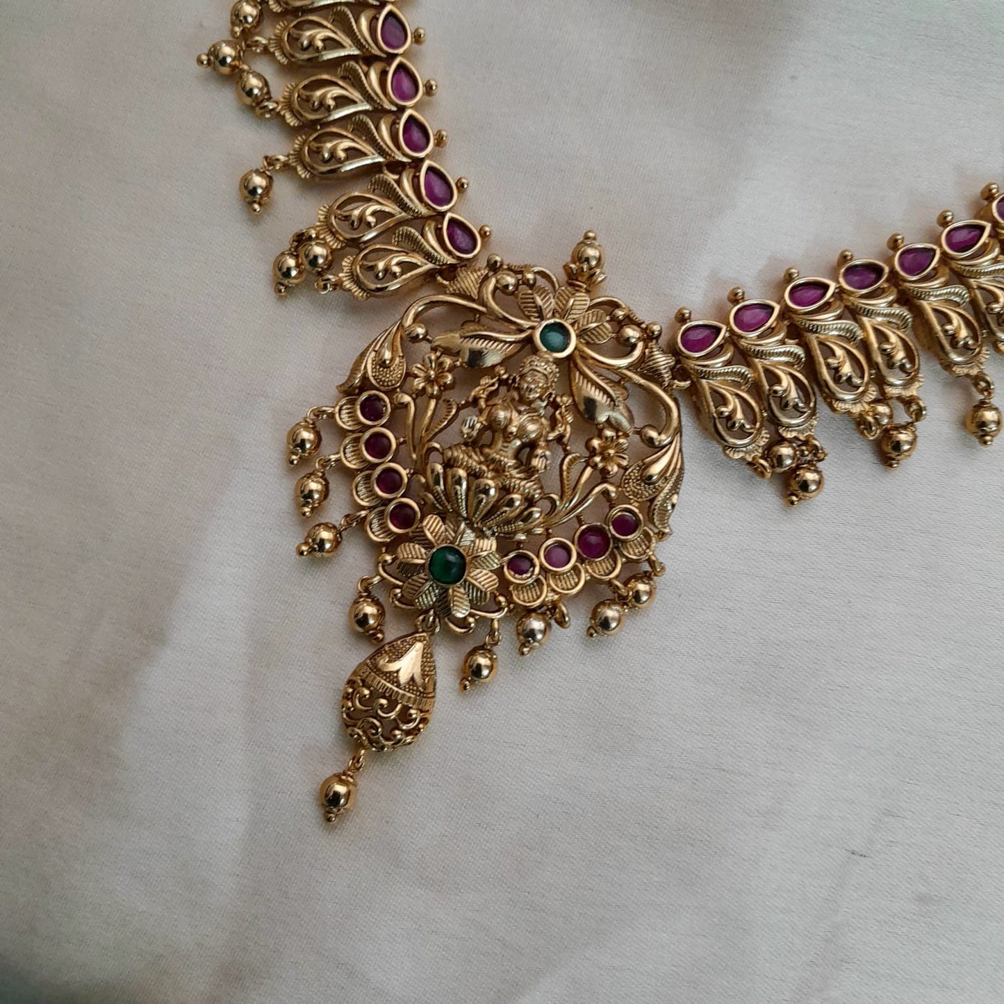 Ruby stone studded lakshmi with floral motif necklace set