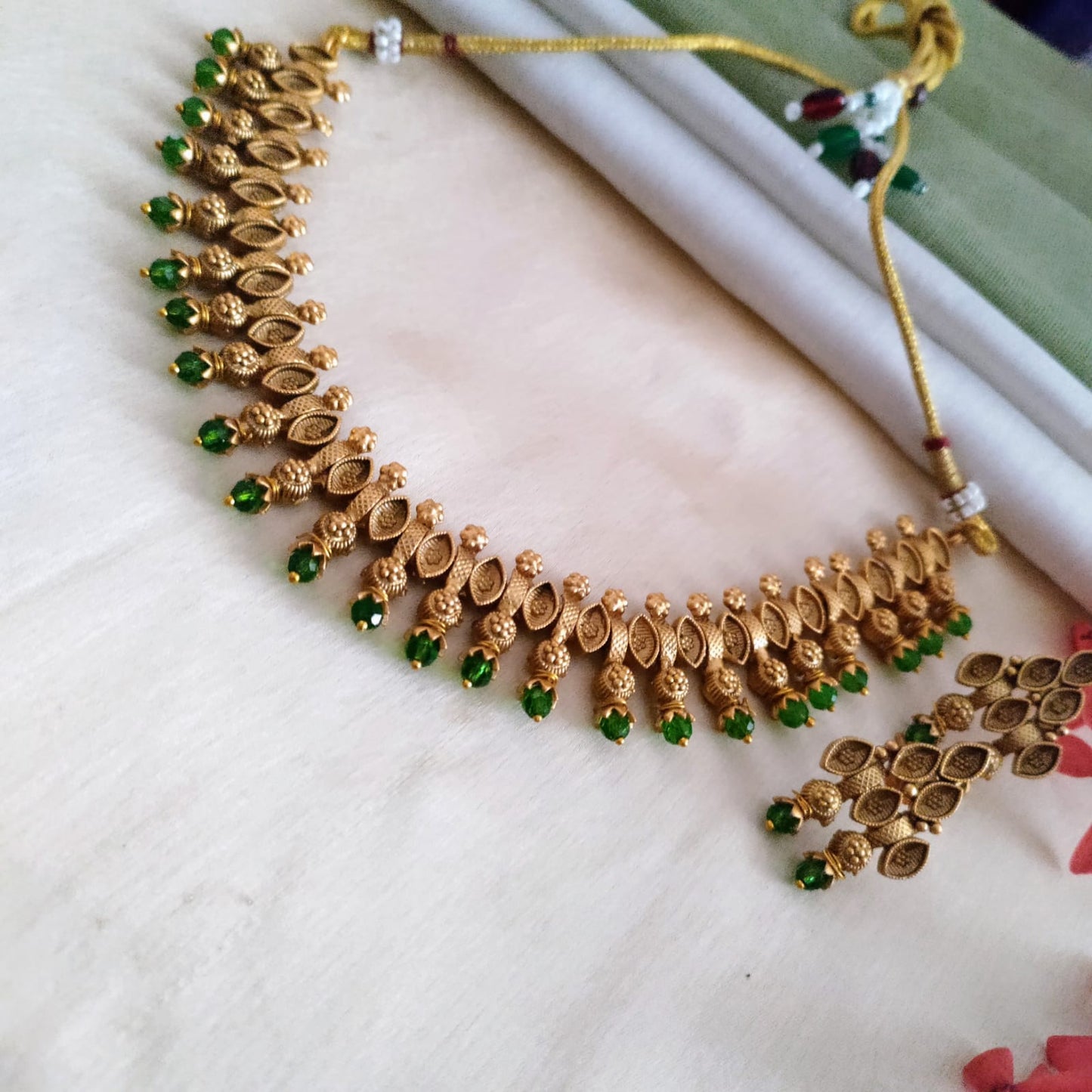 Golden necklace with ruby/emerald/pearl stone
