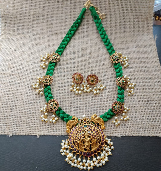 Green threaded necklace set with kemp krishna pendant