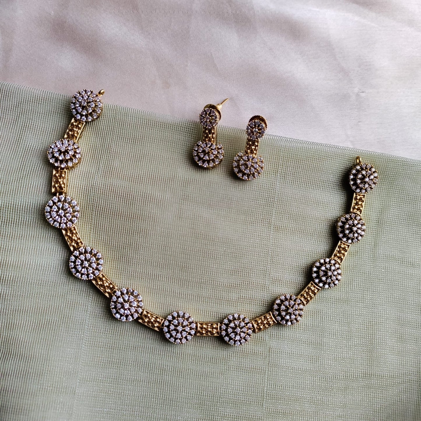 Necklace set, adigai type with round white stone studded pattern around the neck
